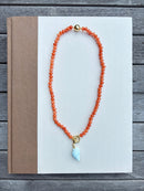 Orange Beaded Necklace with Blue Shell Charm