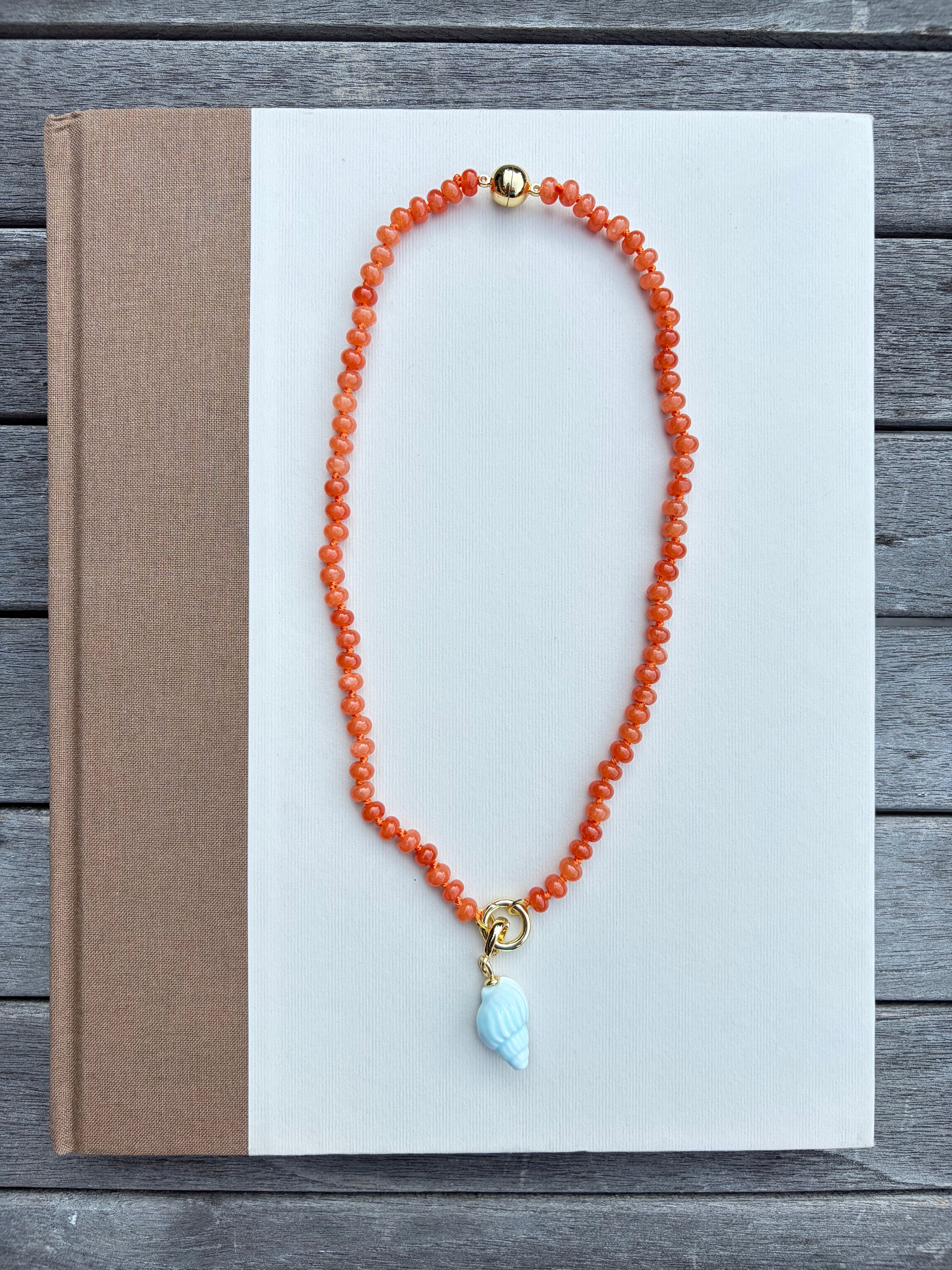 Orange Beaded Necklace with Blue Shell Charm