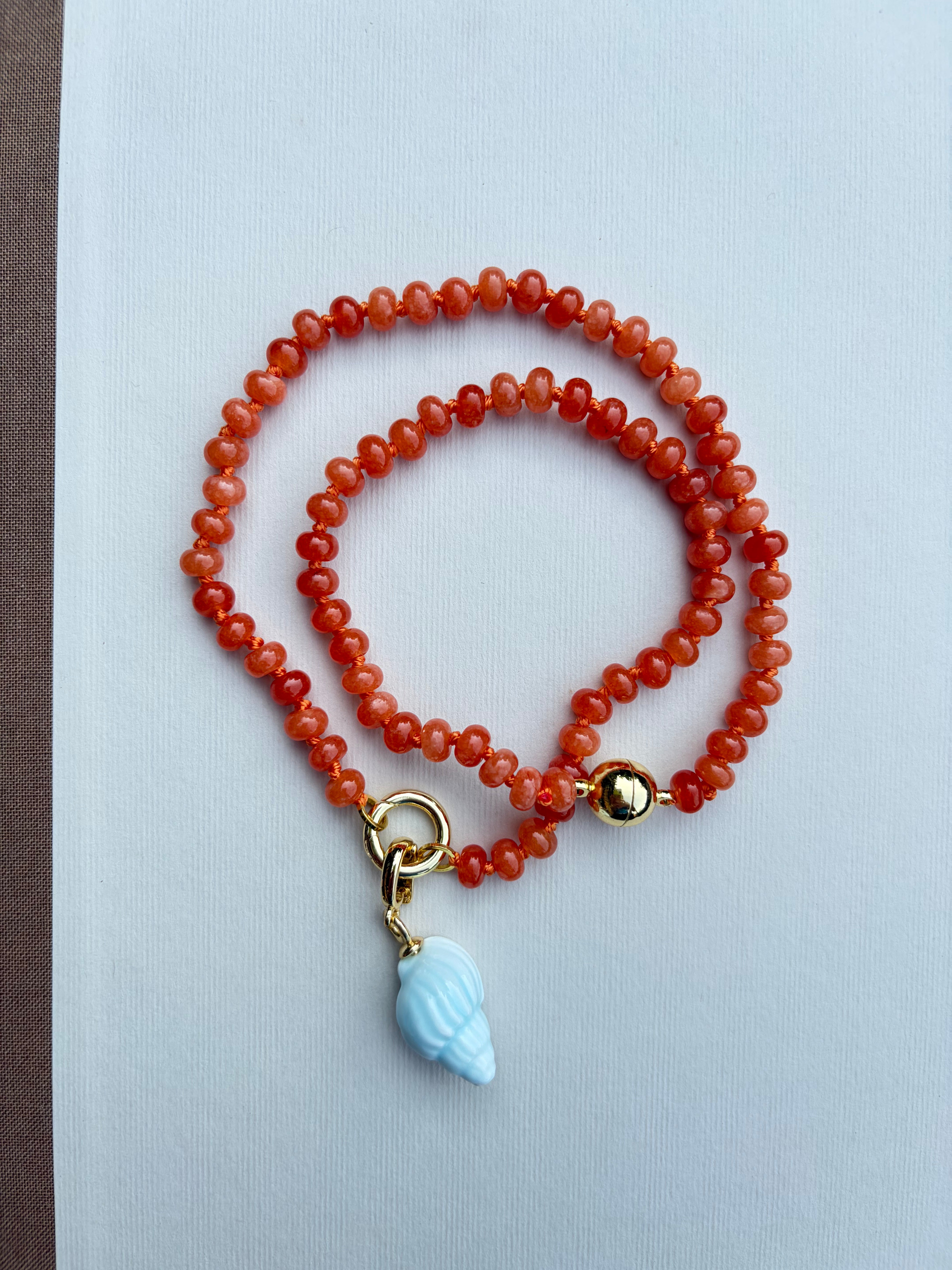 Orange Beaded Necklace with Blue Shell Charm